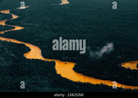 Aerial view of Amazon rain forest, river curves and dense forest with high biodiversity. Acre State, Brazil. Stock Photo