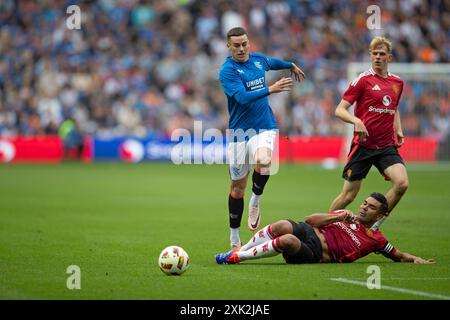 Edinburgh, Scotland, United Kingdom, 20th July 2024 - Carlos Casemiro tackles Tom Lawrence  during the pre-season friendly match at Scottish Gas Murrayfield Stadium, Edinburgh on 20/07/2024 between Manchester United and Rangers - Credit: Thomas Gorman/Alamy News Live Stock Photo