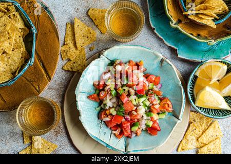 From above of traditional Mexican pico de gallo made with fresh tomatoes, onions, cilantro, jalapenos, and a dash of lemon juice, perfectly served alo Stock Photo