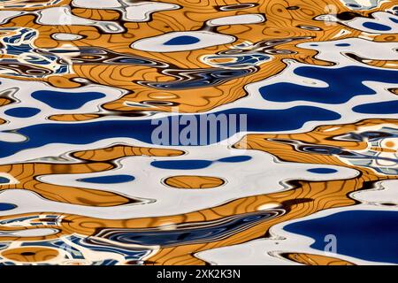 Stunning abstract patterns of water reflections caused by buildings, depicting the juxtaposition of natural fluid dynamics and human engineering in Lo Stock Photo
