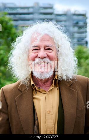 Portrait mature joyful long gray hair and beard male grandfather posing looking smiling at camera. Stock Photo