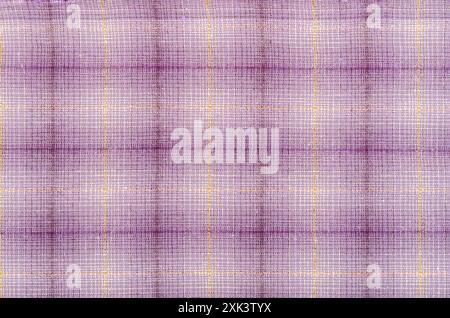 Woven cotton purple fabric with plaid pattern texture as background. Stock Photo