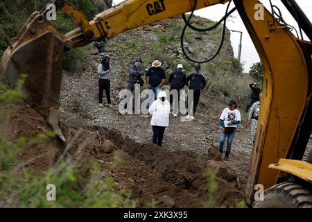 Queretaro, Mexico. 19th July, 2024. A female activist looks on during an excavation During a search day, the Desaparecidos Querétaro collective placed a cross that symbolizes peace on a property in the community of Santa Barbara de la Cueva, in the municipality of San Juan del Río, Querétaro, where 3 bodies have previously been found. They have already been identified. Canines from the National Guard also participated in the search. Credit: SOPA Images Limited/Alamy Live News Stock Photo