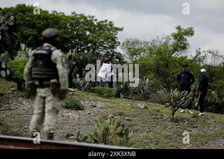 Queretaro, Mexico. 19th July, 2024. Female activists hug each other during a search day. During a search day, the Desaparecidos Querétaro collective placed a cross that symbolizes peace on a property in the community of Santa Barbara de la Cueva, in the municipality of San Juan del Río, Querétaro, where 3 bodies have previously been found. They have already been identified. Canines from the National Guard also participated in the search. (Photo by Cesar Gomez/SOPA Images/Sipa USA) Credit: Sipa USA/Alamy Live News Stock Photo