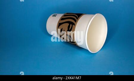 Starbucks cup empty on seamless blue background with copy space Stock Photo