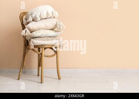 Pillows on chair in room Stock Photo