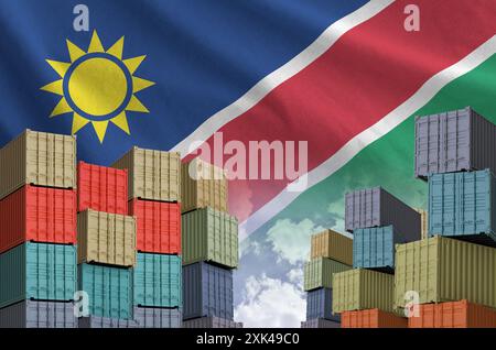 Namibia flag and big stack of shipping cargo containers in docks with ...