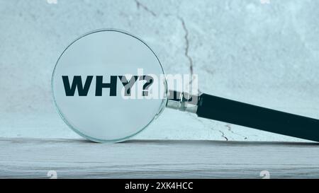 WHY word written through a magnifying glass on the wall. Photos in cold colors Stock Photo