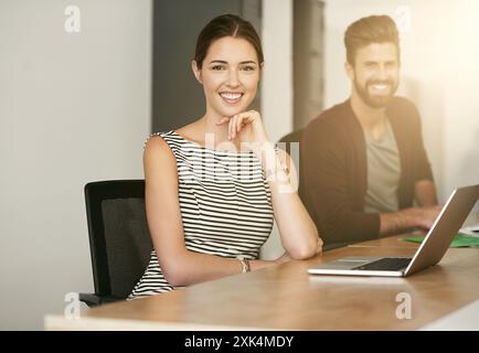 Small business, creative woman and portrait in project meeting for design, office and working at computer. Web designers, desk and face in workplace Stock Photo