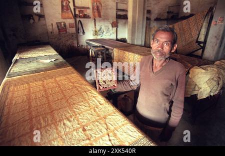 a men at a Family Factory of hand made Batik Textile print at work in the city of Mysore in the Province of Karnataka in India.  India, Mysore, March, Stock Photo