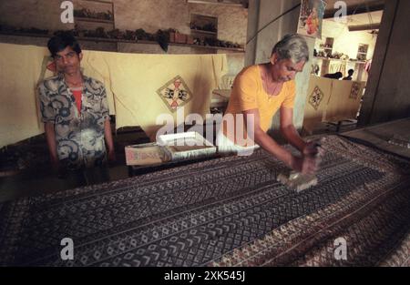 a men at a Family Factory of hand made Batik Textile print at work in the city of Mysore in the Province of Karnataka in India.  India, Mysore, March, Stock Photo