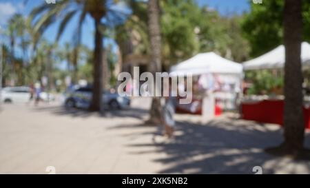 Blurred scene of an outdoor market in mallorca showcasing blurred palm trees, a woman, street vendors, defocused people, vibrant market stalls, and a Stock Photo