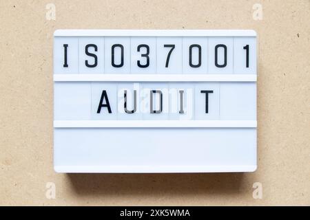 Lightbox with word ISO 37001 audit on wood background Stock Photo