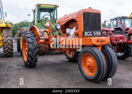 Ballymena, Northern Ireland - July 20th, 2024: vintage tractor and steam engine rally, minimalist orange Allis Chalmers machinery. Stock Photo