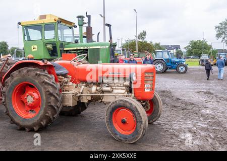 Ballymena, Northern Ireland - July 20th, 2024: vintage tractor and steam engine rally, red Zetor 4011 in front of John Deere 7520. Concept classics. Stock Photo