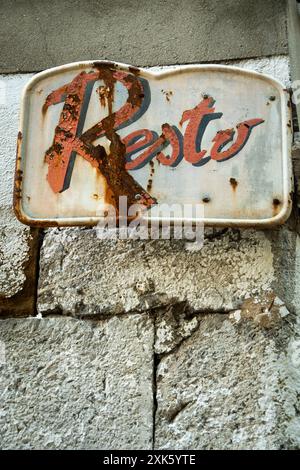Rusty Metal Sign With Resto Written in Red and Black Stock Photo