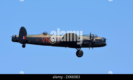 Vintage Avro Lancaster world war 2 bomber with wheels down in flight. Stock Photo