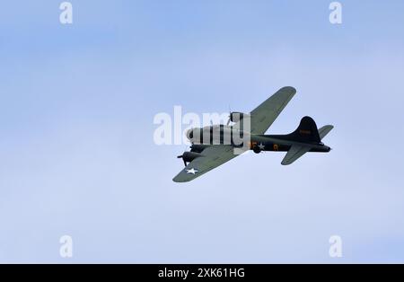 Vintage  B-17 Flying Fortress G-BEDF Sally B in flight blue sky. Stock Photo