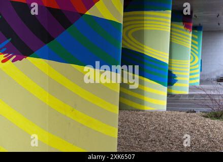 Dundee, Scotland – March 24 2024:The pillars in an underpass, painted in psychedelic colours and effects Stock Photo