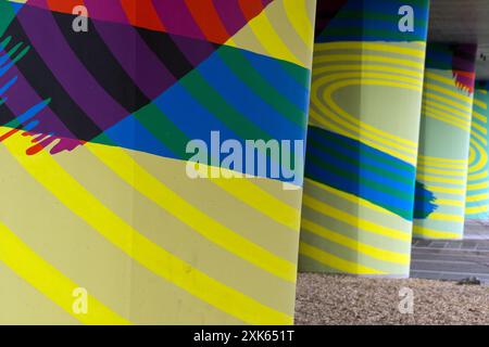 Dundee, Scotland – March 24 2024:The pillars in an underpass, painted in psychedelic colours and effects Stock Photo