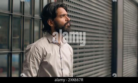 Serious pensive indian man thoughtful male businessman bearded entrepreneur thinking ponder business issues alone dreamy face arabian guy customer Stock Photo