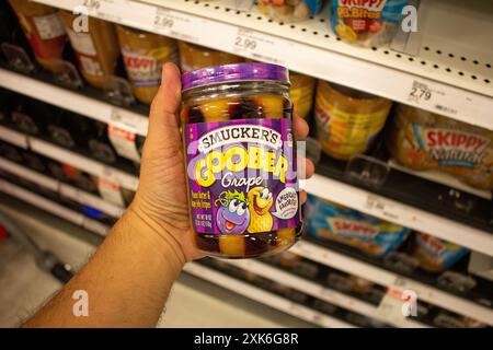 Los Angeles, California, United States - 03-18-2021: A view of a hand holding a jar of Smucker's Goober Grape, on display at a local grocery store. Stock Photo