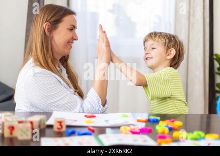 Mother and son high five at home Stock Photo
