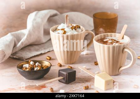 Two cups with hot chocolate dipping sticks and marshmallows Stock Photo