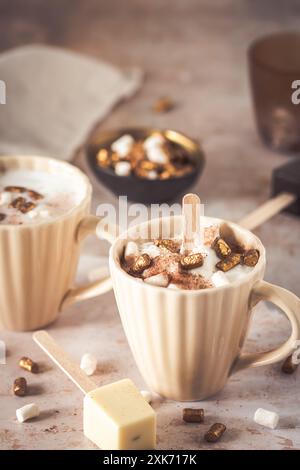 Two cups with hot chocolate, dipping sticks and marshmallows, vertical Stock Photo