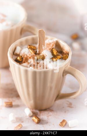 Cup with hot chocolate dipping sticks and marshmallows, vertical Stock Photo