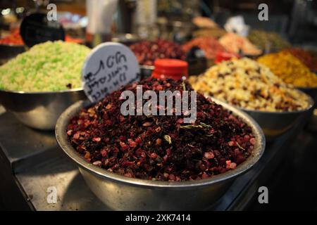 Different infusions for brewing tea each of various fruit, color and flavor like pomegranate in front , stand in the Machane Yehuda Market Stock Photo