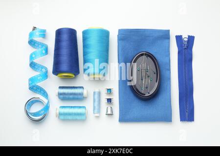Flat lay composition with different sewing supplies on white background Stock Photo