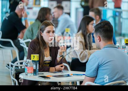 Moscow - April 10,2024: Professionals networking and engaging in discussions at business event Open Innovations Conference in Skolkovo Technopark at modern hall Stock Photo