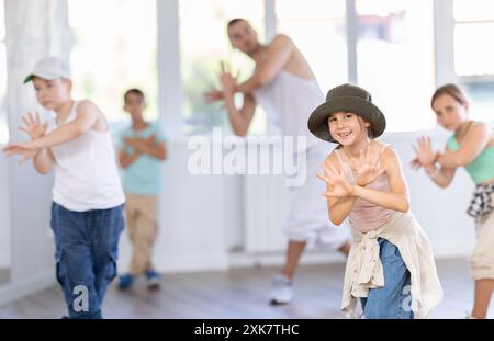 Tween girl mastering krump dance in children dance studio Stock Photo