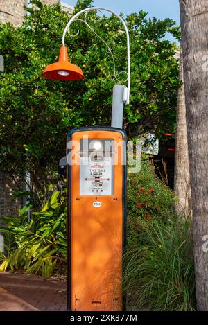 Gilbarco vintage gas pump with an orange light fixture on the top of the gasoline dispenser. The meter on the gas pump is in dollars and gallons. Stock Photo