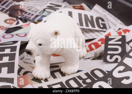 Polar bear on cut newspaper titles Stock Photo