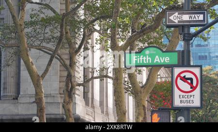 Fifth avenue, 5 ave road sign, Manhattan midtown architecture, New York City 5th av, 42 street corner near Bryant Park and Library. Traffic crossroad one way arrow signage, USA. Stock Photo