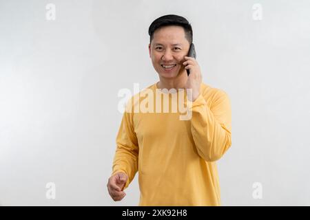 Happy caucasian young man using smart phone cellphone for calls, social media, mobile application online isolated in white background Stock Photo