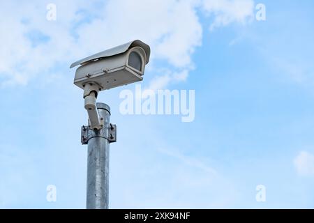 CCTV security cameras in office buildings. Modern CCTV camera on the wall, blurred morning cityscape background, concept of surveillance and monitorin Stock Photo