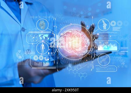 Health worker supports the brain and intellect against. Doctor showing human brain on blue background. Doctor on blurred background using digital brai Stock Photo