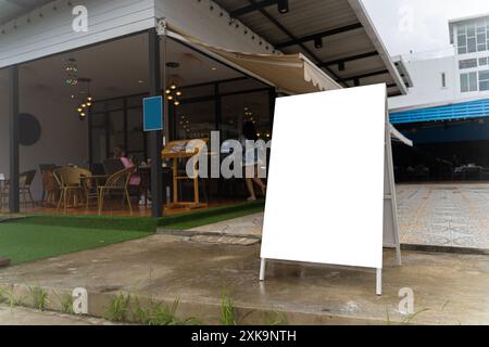 White paper poster mockup displayed outside the building. Marketing and business concept. Displayed in front of restaurants, coffee shop promotion inf Stock Photo