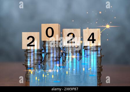 Wooden block cube 2024 on coins stacking for setup objective target business cost and budget planning of new year concept. Money saving ideas and fina Stock Photo