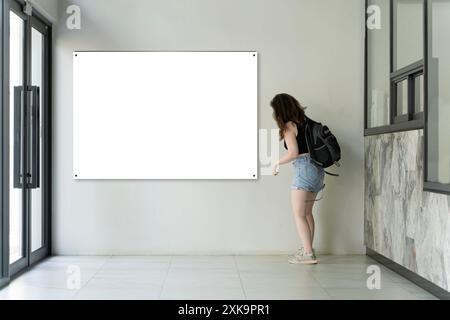 Reception counter in hotel, big banner on wall, mock-up. Indoor Registration DeskTable In Hotel or Reception Area, white and blank space for branding Stock Photo
