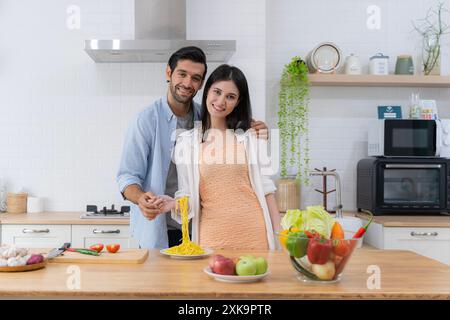 Romantic couple enjoying lunch in the restaurant, eating paste and drinking red wine. Lifestyle, love, relationships, food concept. Happy young man ea Stock Photo
