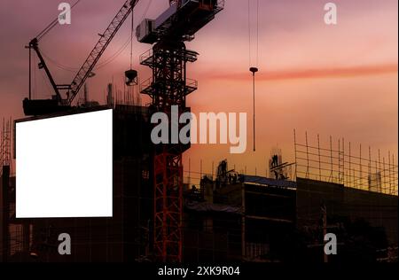 Blank white banner for advertisement hanging on the scaffolding of modern building under construction. An empty space for your content. Beautiful suns Stock Photo
