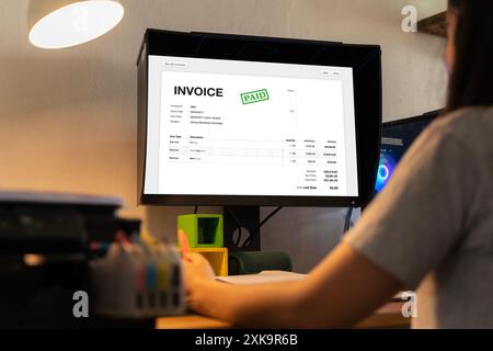 Chartered Tax Accountant Using Modern Invoice Billing Software. Business Invoice Tax Management. Accountant Using Monitor, studying financial business Stock Photo