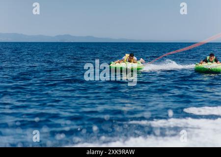 Exciting summer speedboat tubing adventure on the sea with friends Stock Photo