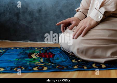 Muslim man praying indoors to god. Muslim men praying in Tashahhud posture Stock Photo