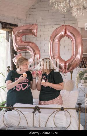 Two girlfriends celebrating their 50th birthday Stock Photo