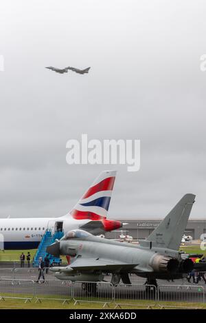 Farnborough Airport, Hampshire, UK. 22nd Jul, 2024. The world’s military and civil aviation businesses have gathered to display and view the latest in aerospace technology. The most modern civilian airliners and military fighters and helicopters are on show. A flypast by two RAF Eurofighter Typhoon fighter jets at 10am opened the show under overcast skies Stock Photo